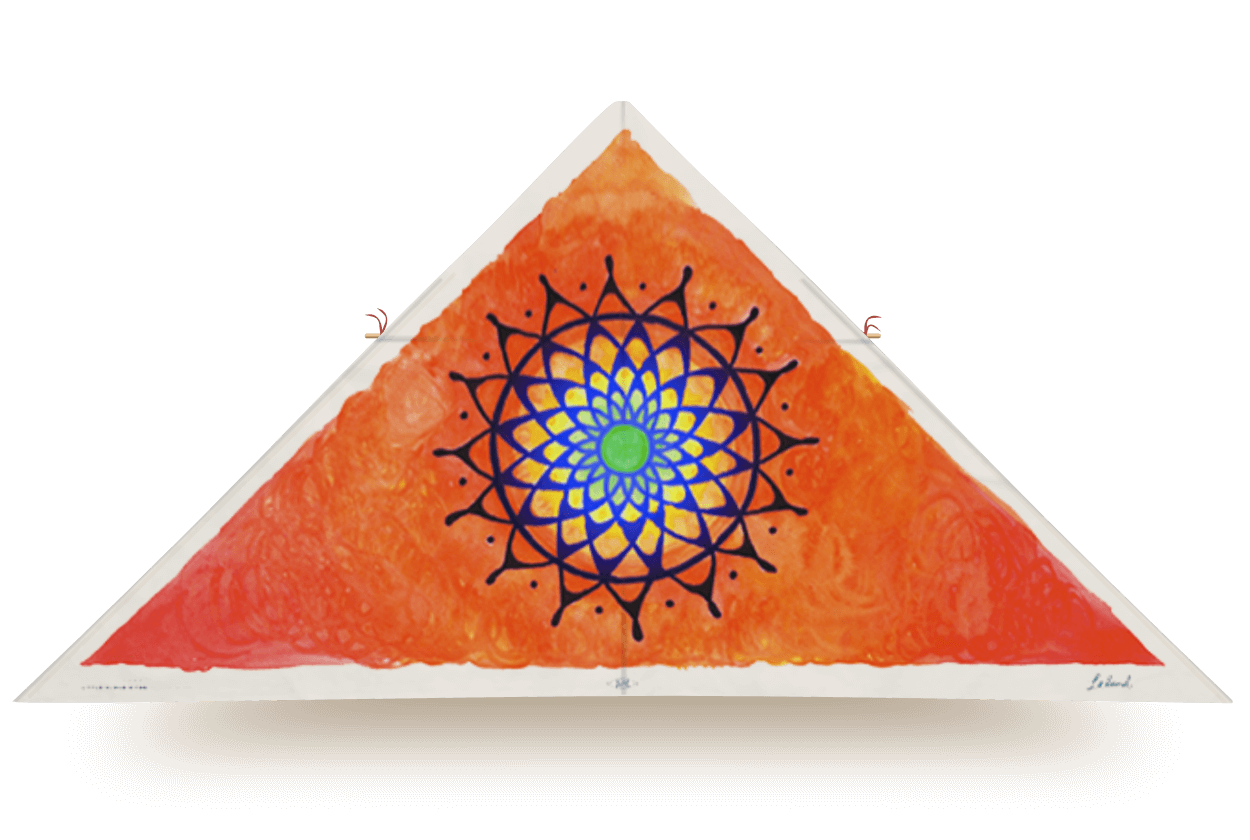 Delta kite titled Shakti with a radiant orange background and central mandala in blue, yellow, and green, designed by Leland Wong-Daugherty